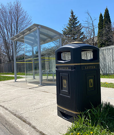 City of Hamilton garbage bin beside an HSR bus shelter