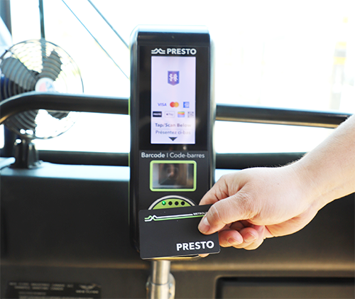A hand tapping a PRESTO card on an HSR bus