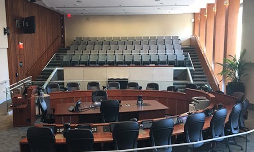 City Hall Council Chambers, circle of chairs and speakers podium