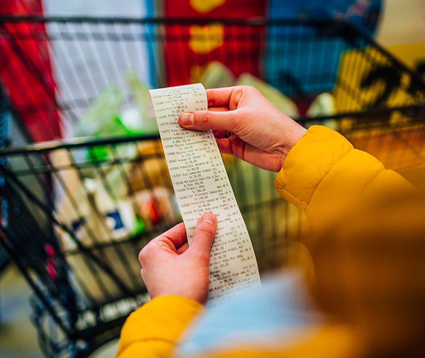 Woman checking the bill when paying at a supermarket