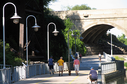 People walking and rollerblading on the Waterfront Trail along Hamilton Harbour