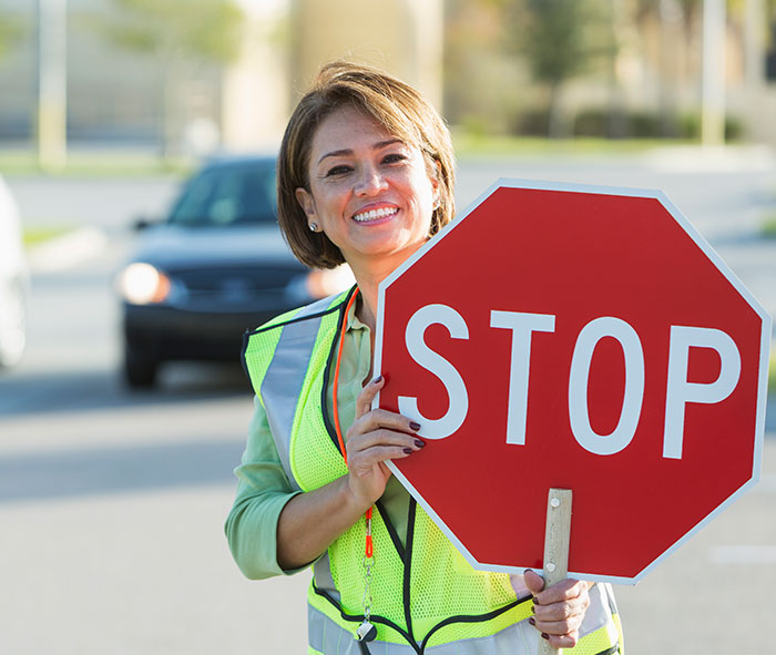 Happy female school crossing guard