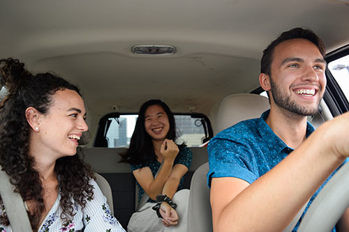 Three people sharing a ride in a car