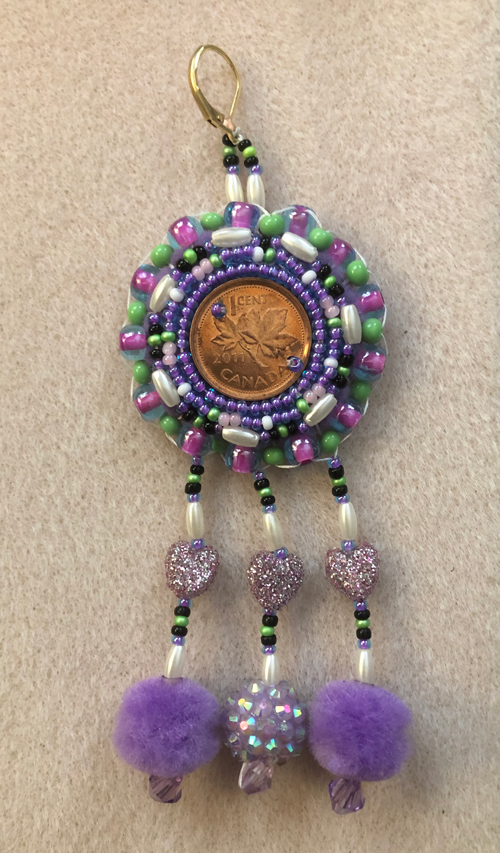 a Canadian penny decorated with beads