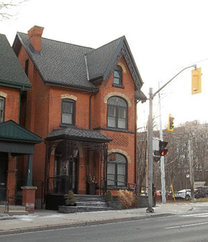 Three story victorian red brick house.