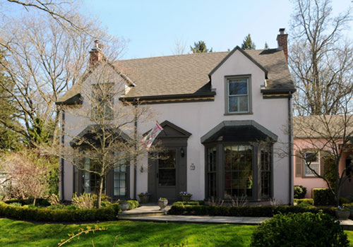 Two storey colonial house with pink stucco.