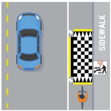 Checkered box in bus lane beside sidewalk to indicate that bikes must yield to people on foot.