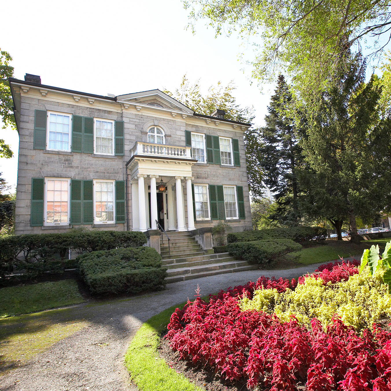 Exterior of Whitehern a 2 storey grey brick building with front porch and circular drive