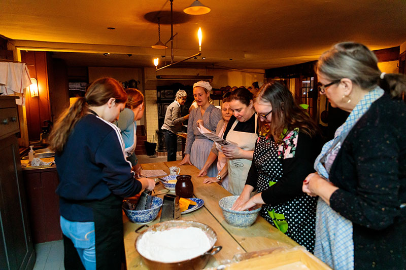 People participating in the Dundurn Christmas Pudding club event - mixing dough