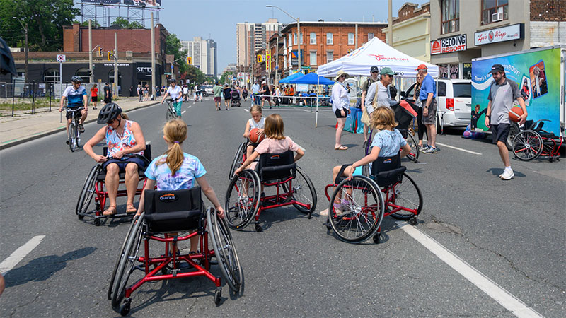A group of wheelchair users on King Street during open streets 2023