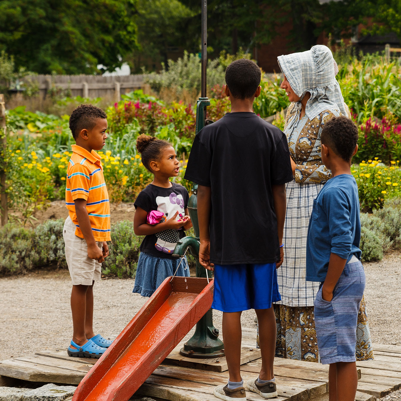Kids at garden fountain in Kitchen Garden at Dundurn