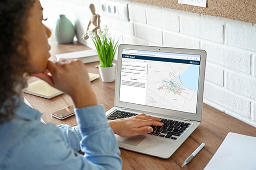 Woman browsing HSR real time alerts map on laptop