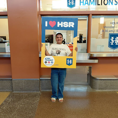 HSR’s Track Your Trip Study winner Amanpreet posing with I Love HSR sign
