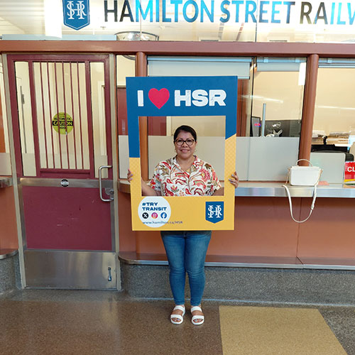 HSR’s Track Your Trip Study winner Elsy posing with I Love HSR sign