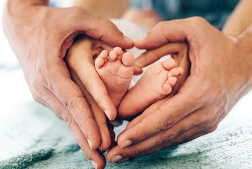 hands holding baby feet