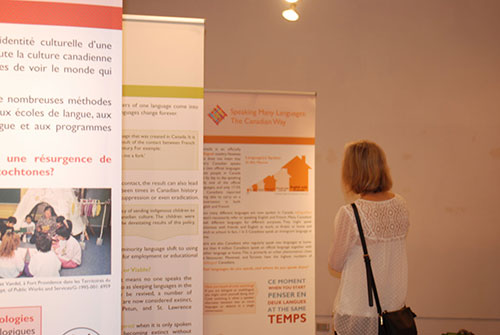 Woman looking at an exhibit with writing and photos