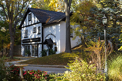 Exterior of Fieldcote Museum in the fall, surrounded by gold and green foliage 