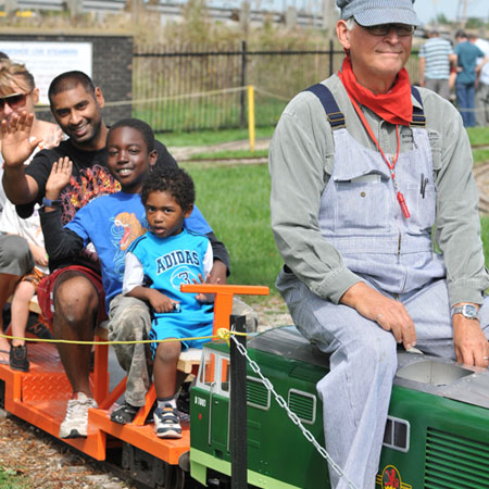 adults and children take a ride on the mini steam train at the Hamilton Museum of Steam &Technology