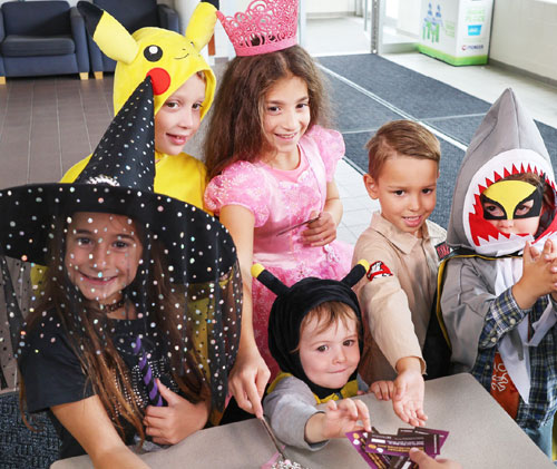 Several children dressed up in Halloween costumes