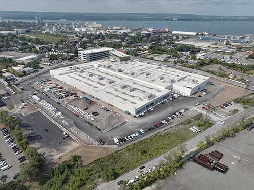 Photo taken September 9, 2025, view looking northwest, DARTS parking lot in foreground and compressed natural gas station along left side of photo. Overhead Administration Building and Parking Structure at the top of the photo.