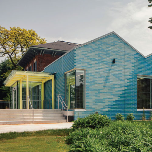 Expansion renovation of bright colours and strong geometical shapes with new exhibition and program space with covered deck