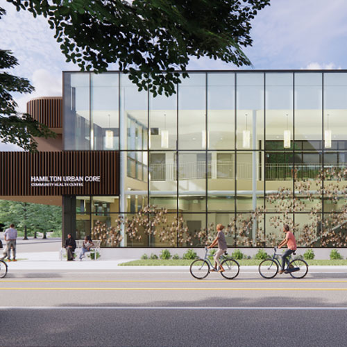 Open double-height atrium building with second story exterior courtyard on Cannon Street East.