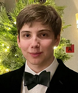 Photo of Samuel Neiterman: A young man with short brown hair, wearing a black suit and bow tie, smiling at the camera.