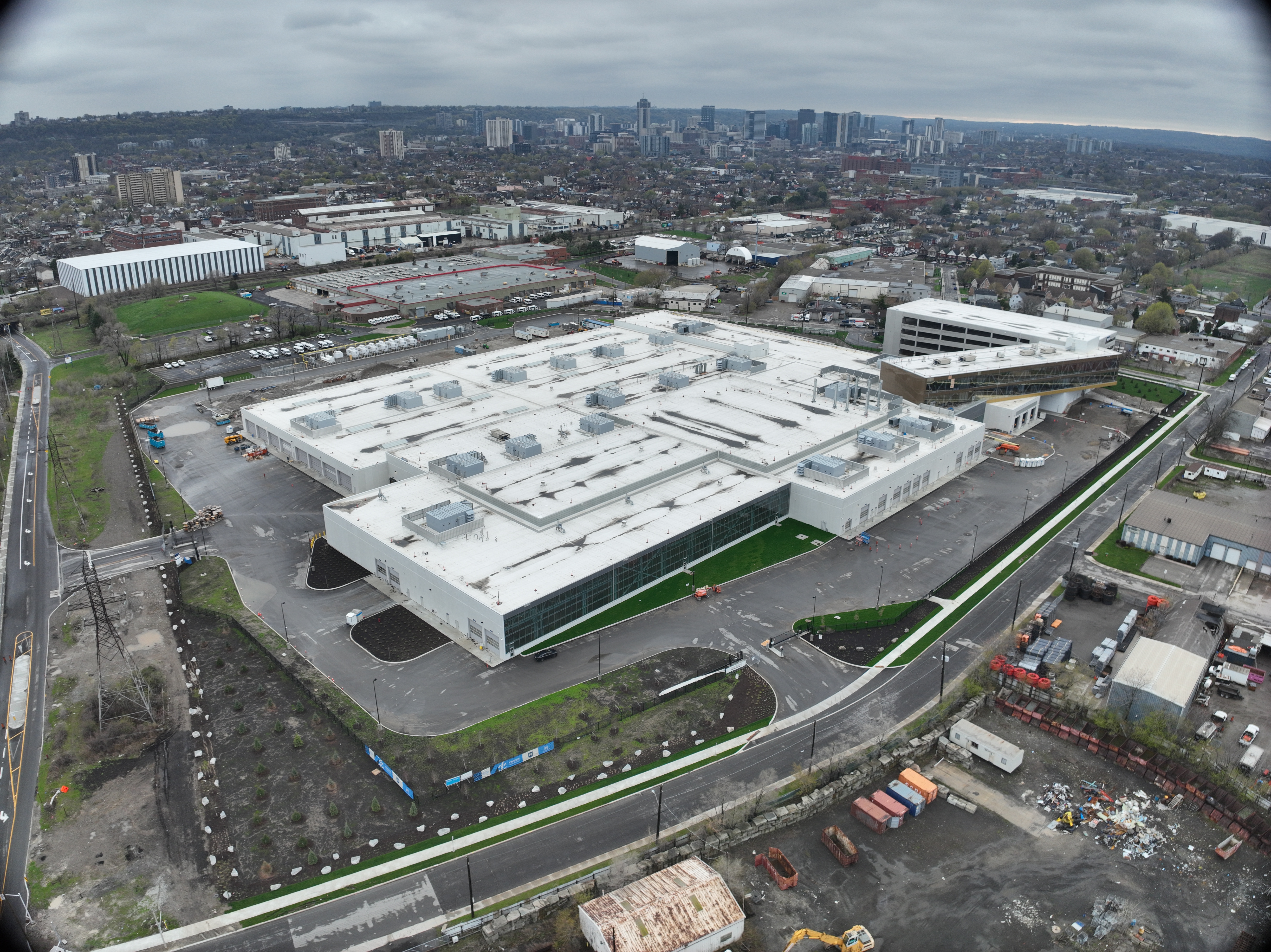 Picture taken April 24, 2026. Looking southwest from the corner of Birch at Brant towards downtown Hamilton. The site is nearing completion, interior finishes and building systems are being finalized.