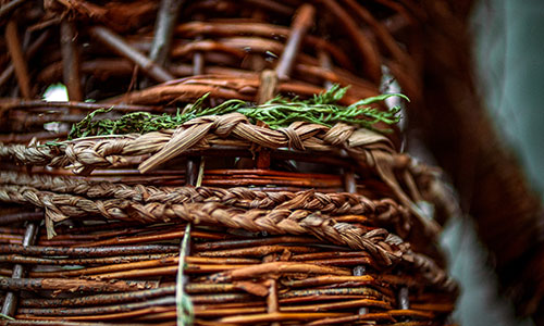 Right to Repossess sculpture is made out of willow, a cedar post, corn husk, wood, clay, material, and ribbon