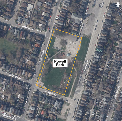 Overhead street view of Powell park, showing a yellow border around the park from Harvey street to the south, to Stirton St to the west, Huron St in the north and Birch Ave to the east