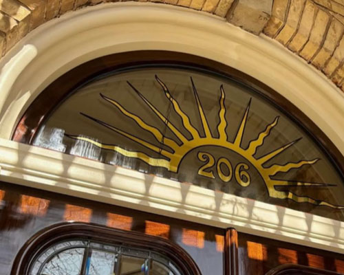 Hand crafted painted signage on glass storefront