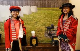 2 young girls dressed in turn of the century military attire