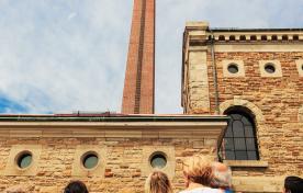 group of people looking up at Steam Museum tower during tout