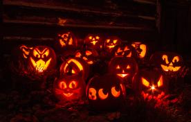 Group of carved pumpkins at night for Halloween