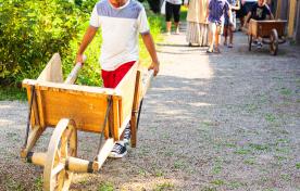 Kids pushing wheelbarrows in kitchen garden at Dundurn National Historic Site
