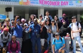 Smiling crowd of newcomers to Hamilton