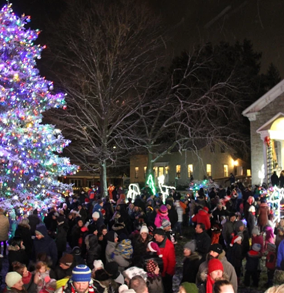 Ancaster Old Town Hall an night with tree lighting and crowd gathered