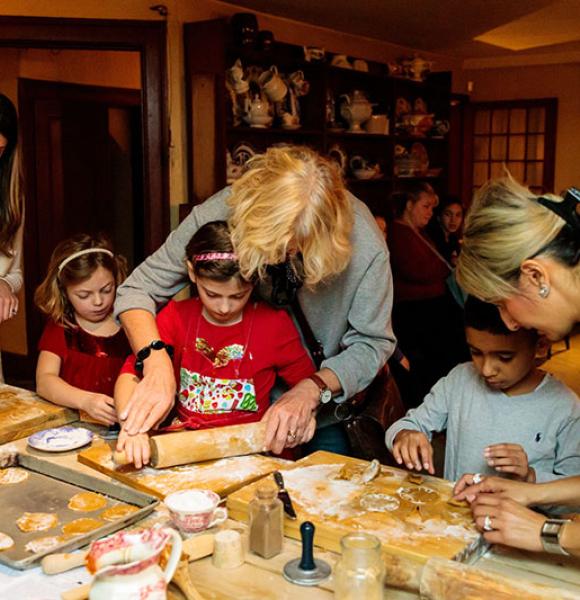 Families with children rolling out dough in the Dundurn Castle kitchen