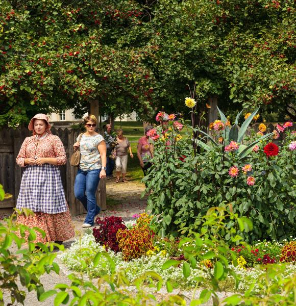 Group of people being led on a tour of gardens at Dundurn National Historic Site