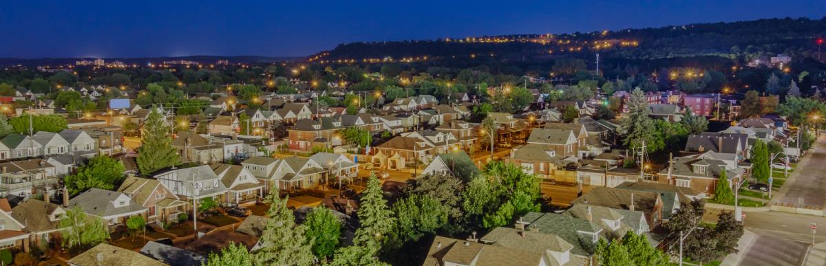 Photo of houses in a residential neighbourhood taken from above in Hamilton, Ontario at night.