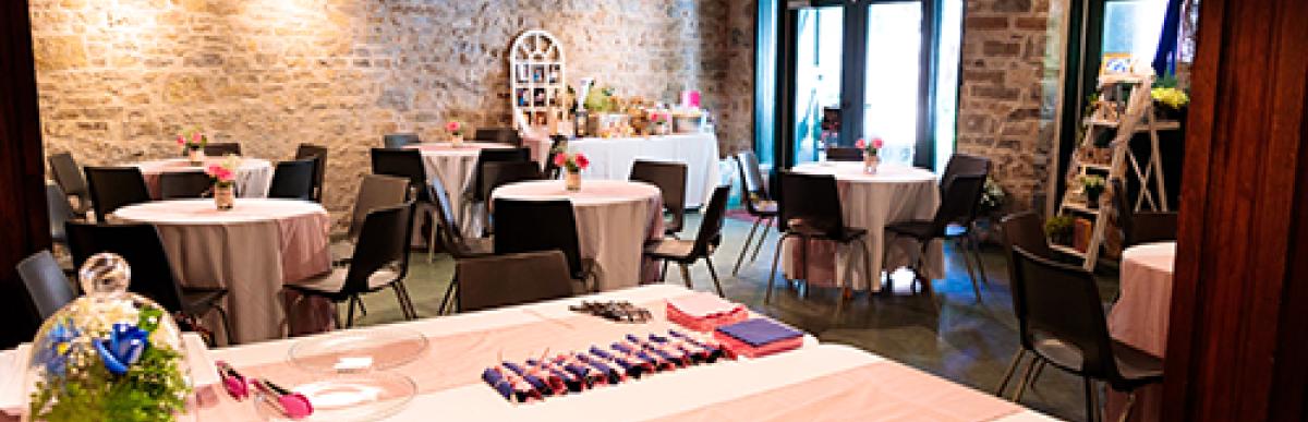 Tables setup inside stone wall building