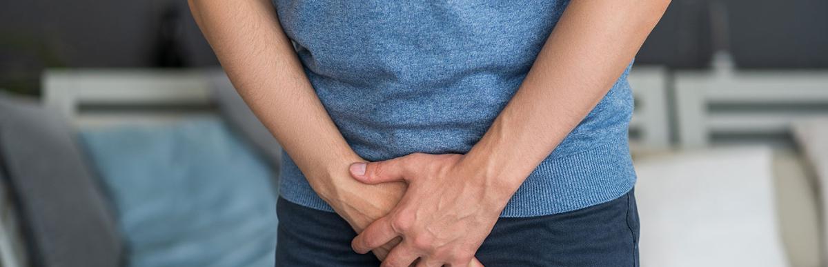 Man holding his crotch suffering from a venereal disease, urological genital infections