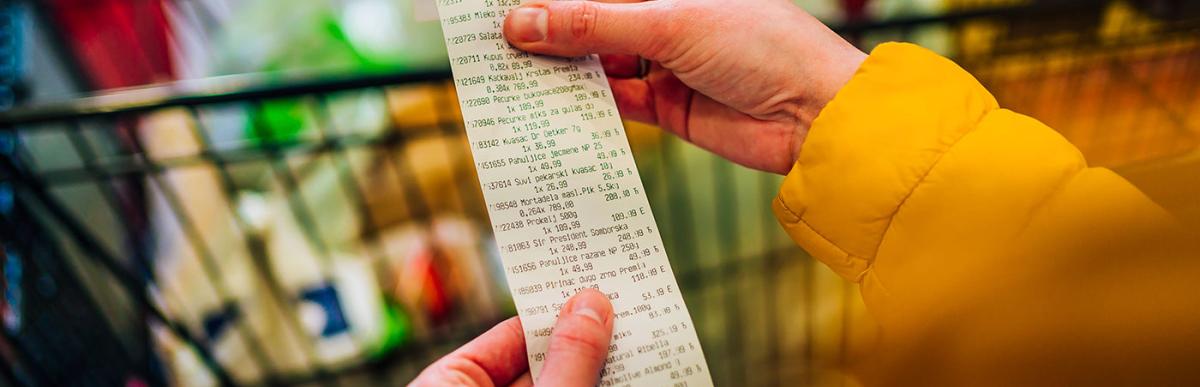 Woman checking the bill when paying at a supermarket