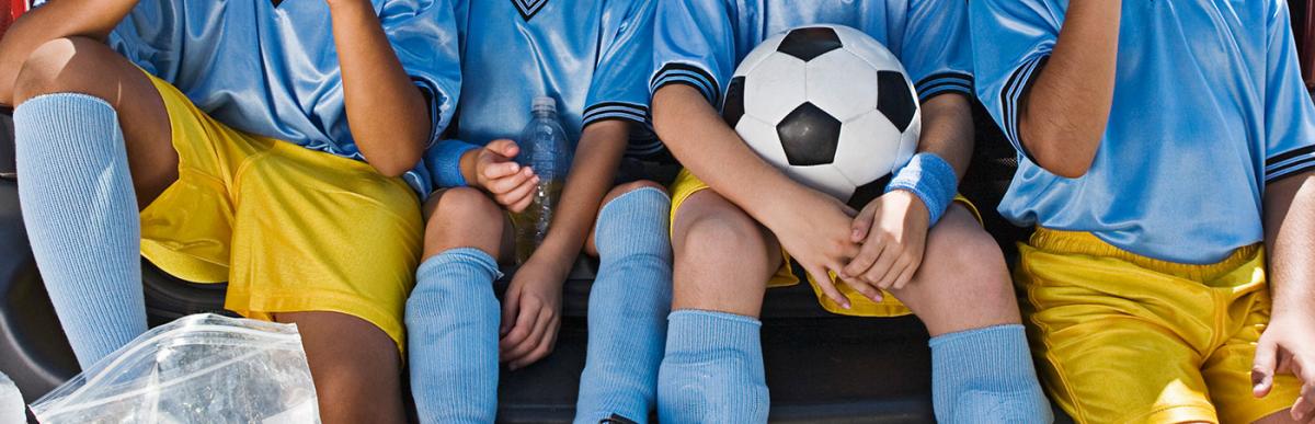 Boys' soccer team in car eating orange slices