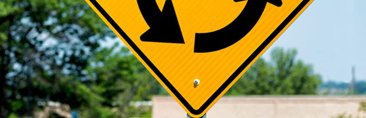 Roundabout street sign in city