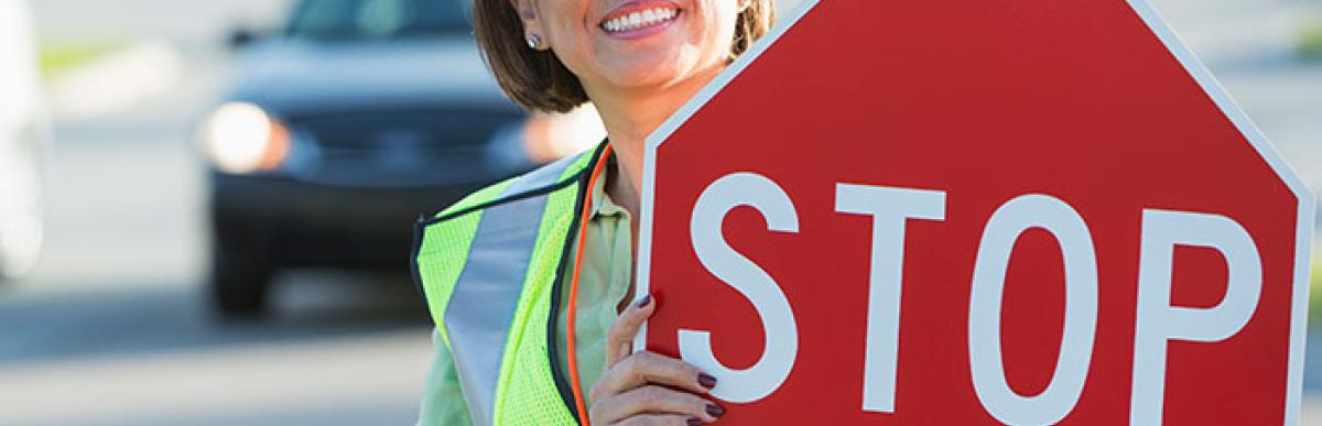 Happy female school crossing guard