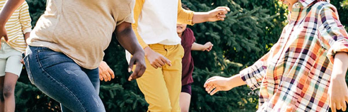 Parents and kids playing soccer together in the backyard