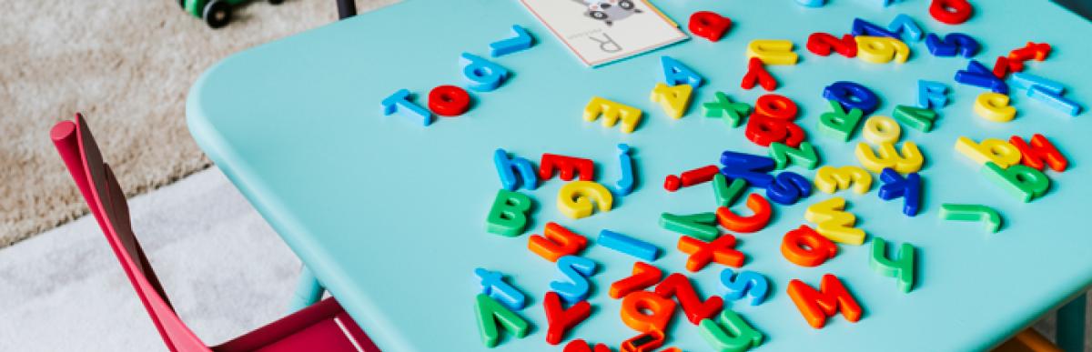 Childs table with chairs in a child care setting with toys.