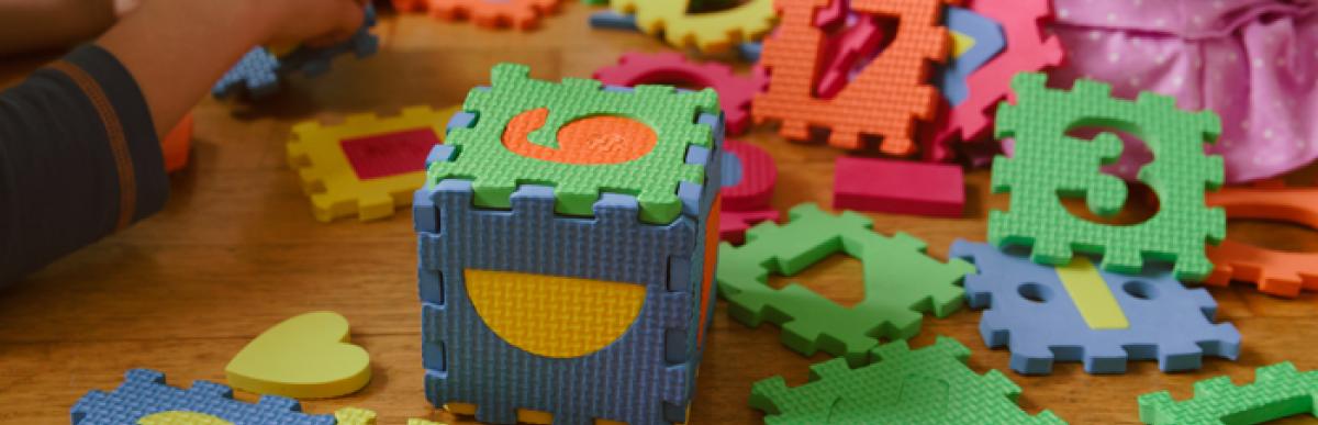 children playing with number puzzle