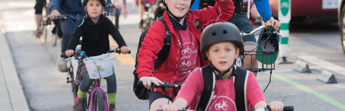 Children and adults riding their bicycles in bicycle lanes